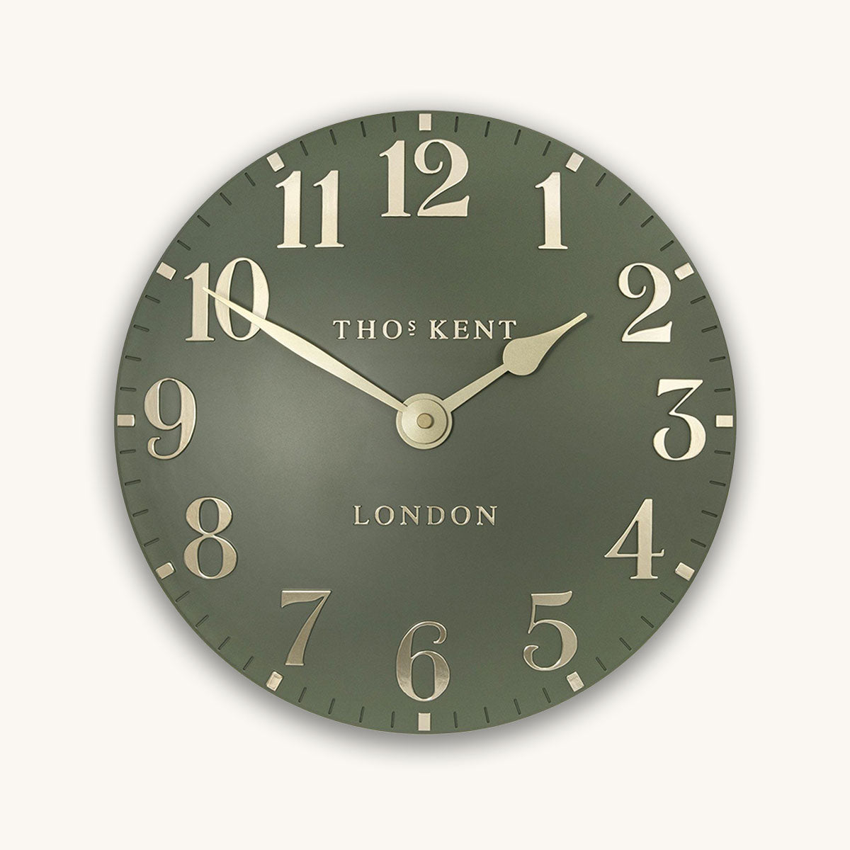 Green clock with gold accents on a white background, featuring the brand 'Thomas Kent'.