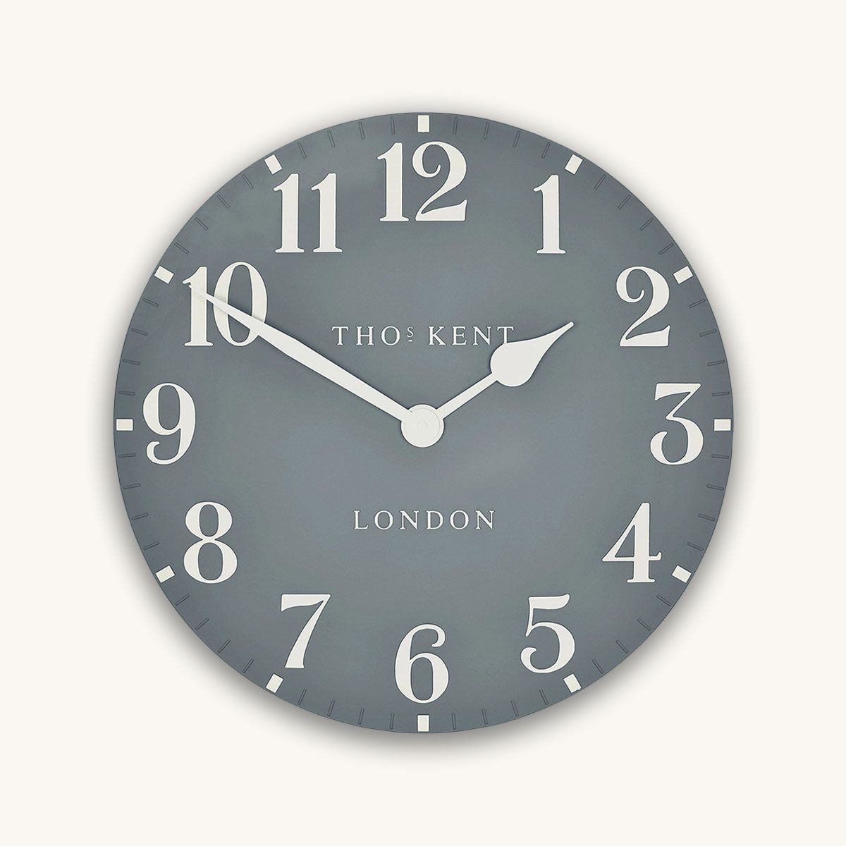 Round wall clock with white numbers and hands on a gray background, featuring the brand 'Thos. Kent'.