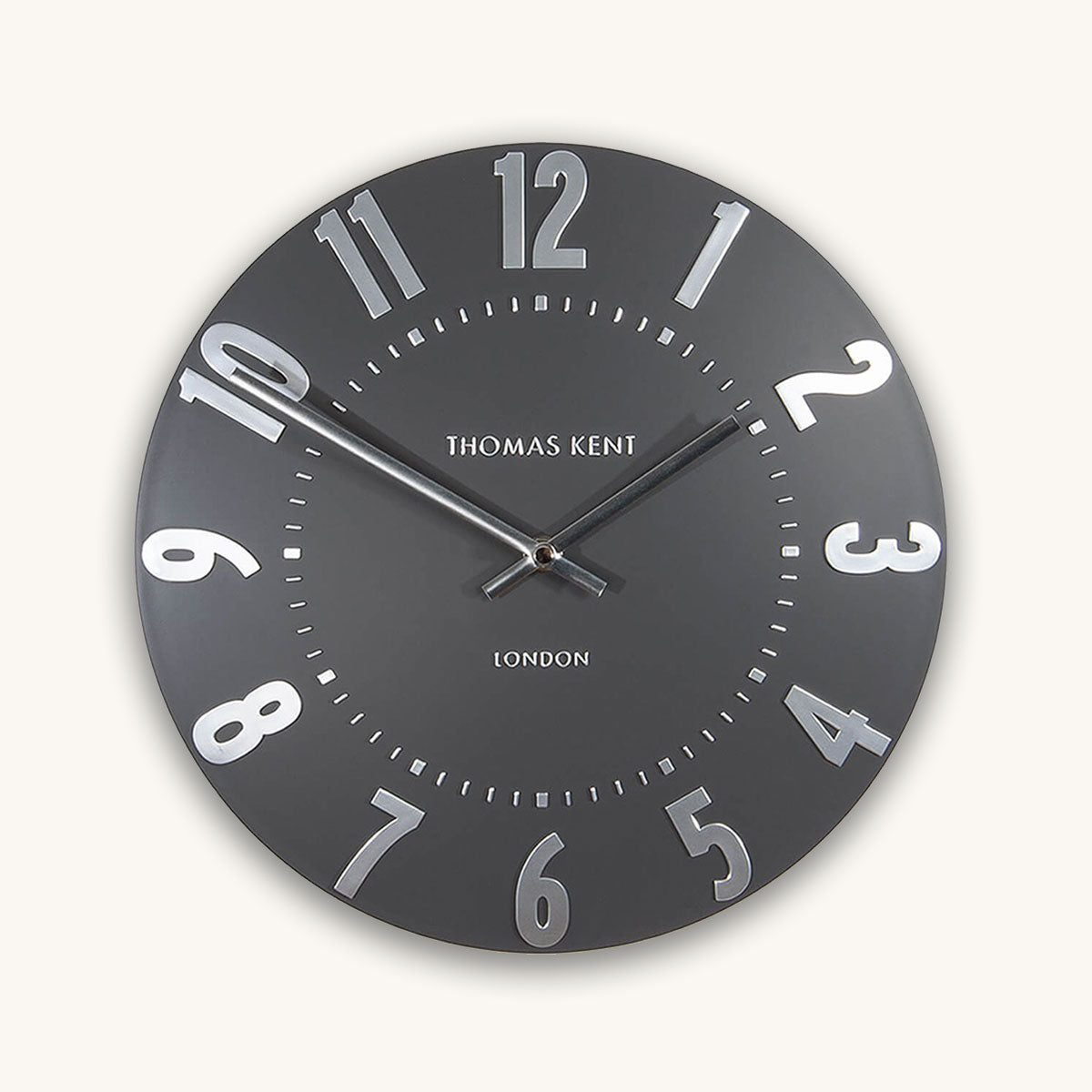 Round wall clock with black face and white numbers on a white background, branded 'Thomas Kent'.