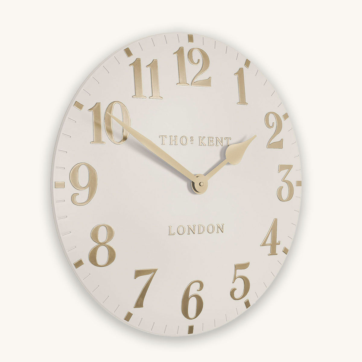 Round wall clock with gold numbers and 'Thomas kent London' branding on a white background