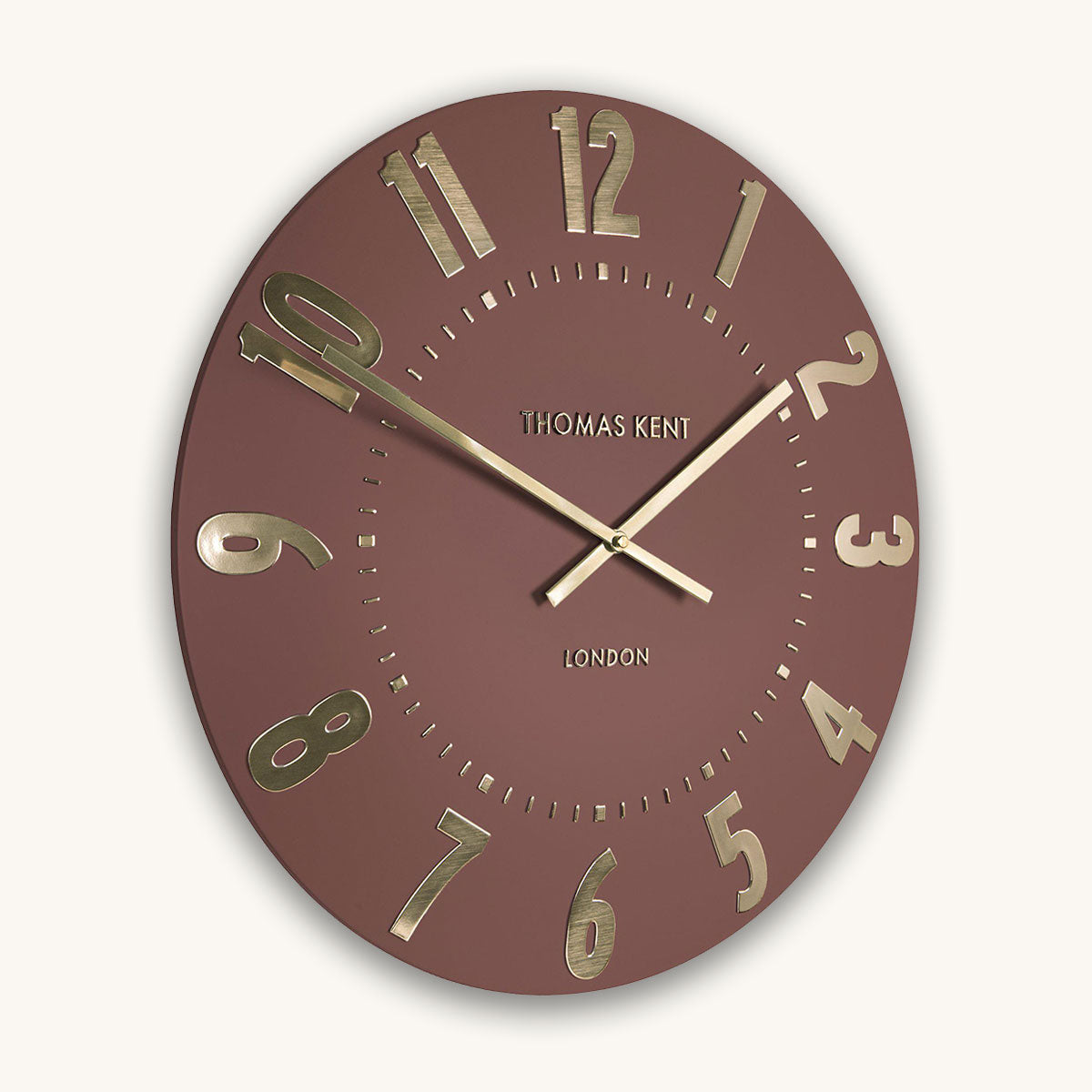 Red wall clock with gold numbers and hands on a white background