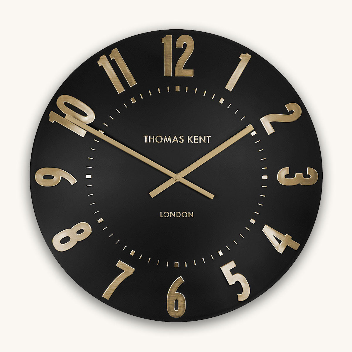 Black wall clock with gold numbers and 'Thomas Kent London' branding on a white background