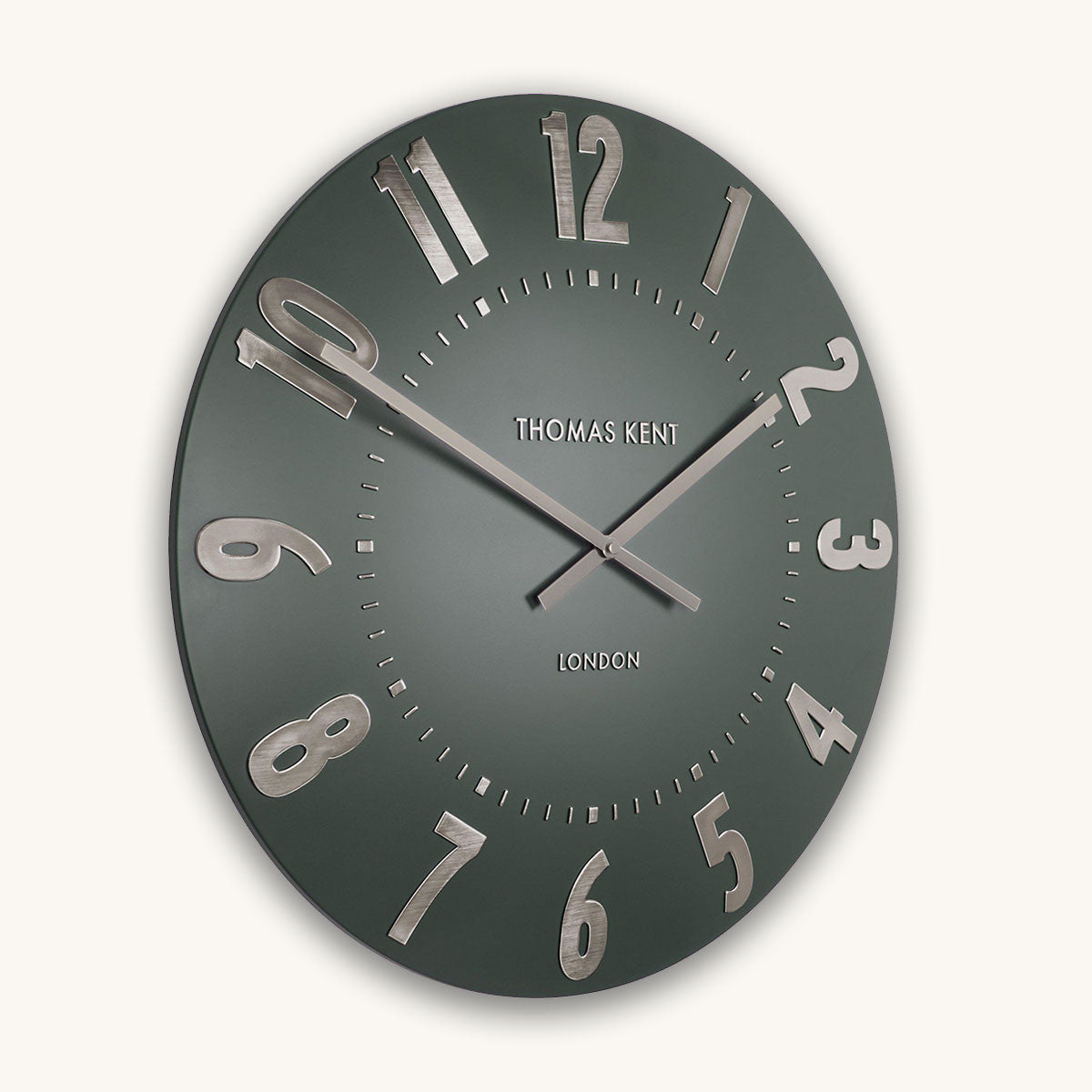 Dark green wall clock with silver numbers and 'Thomas Kent London' branding on a white background