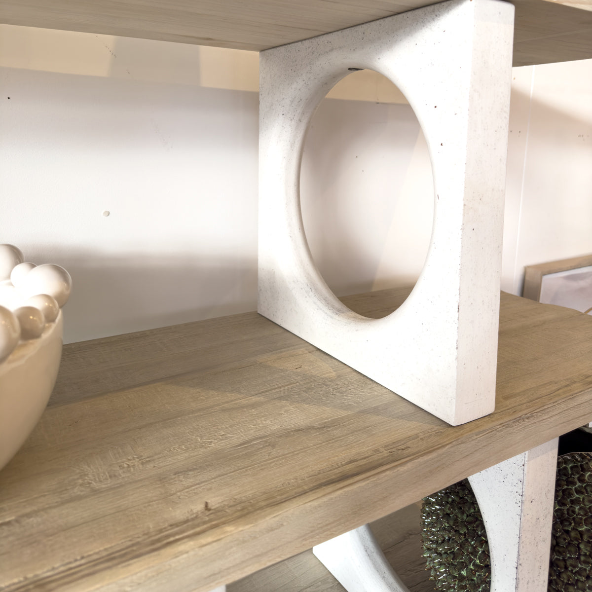 Wooden shelf with a white concrete block on top