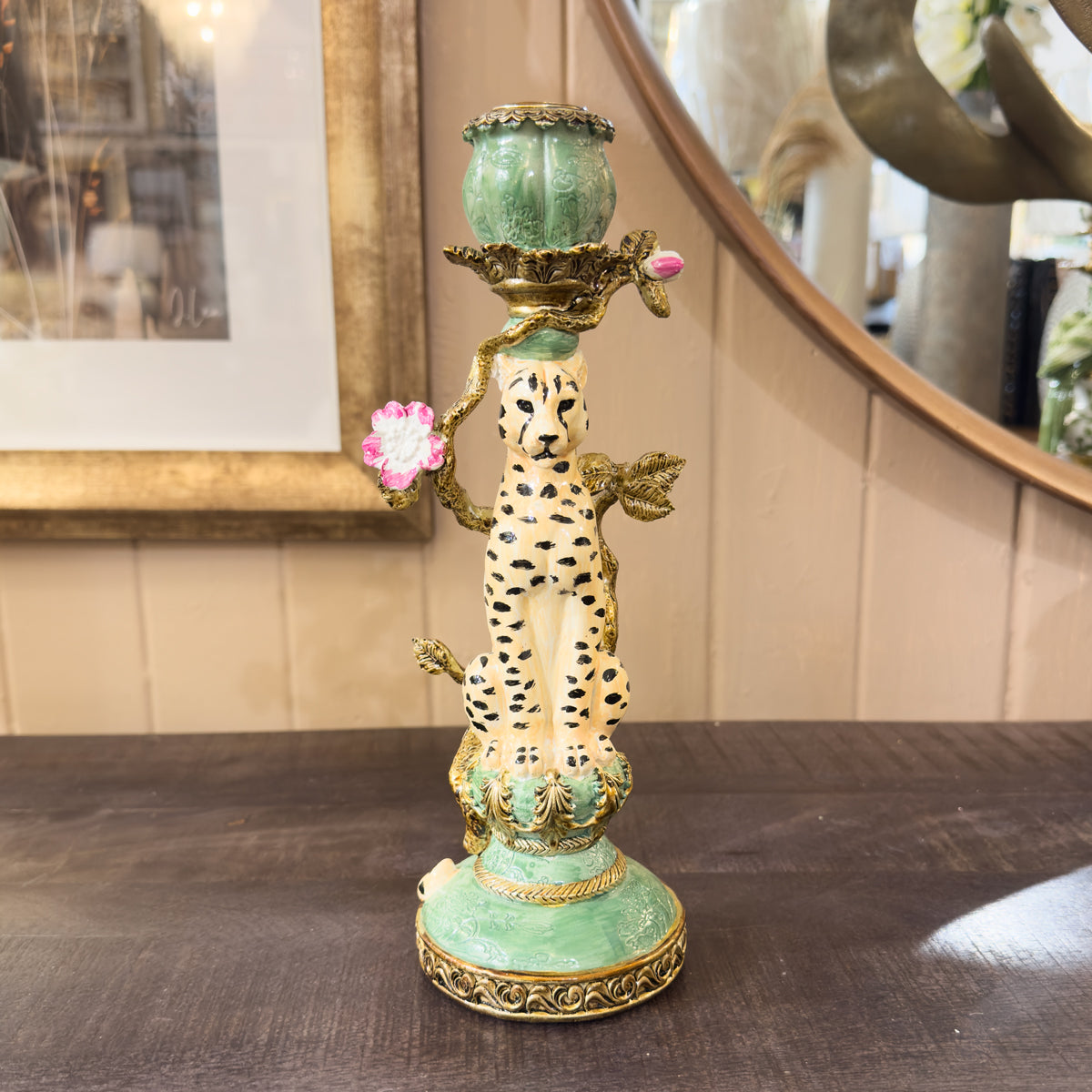 Decorative candlestick holder with cheetah design on a wooden surface