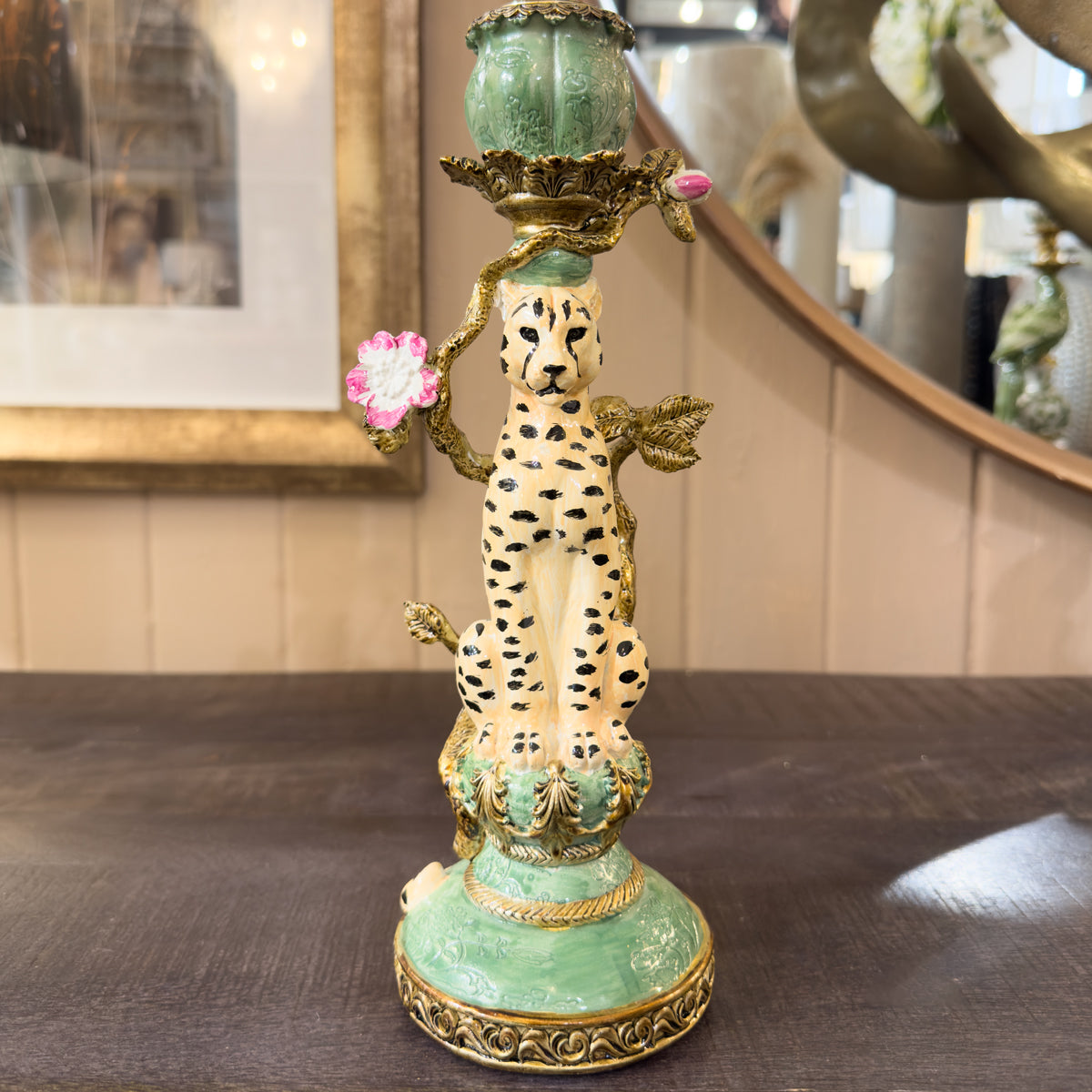Ceramic candleholder with animal design on a wooden surface
