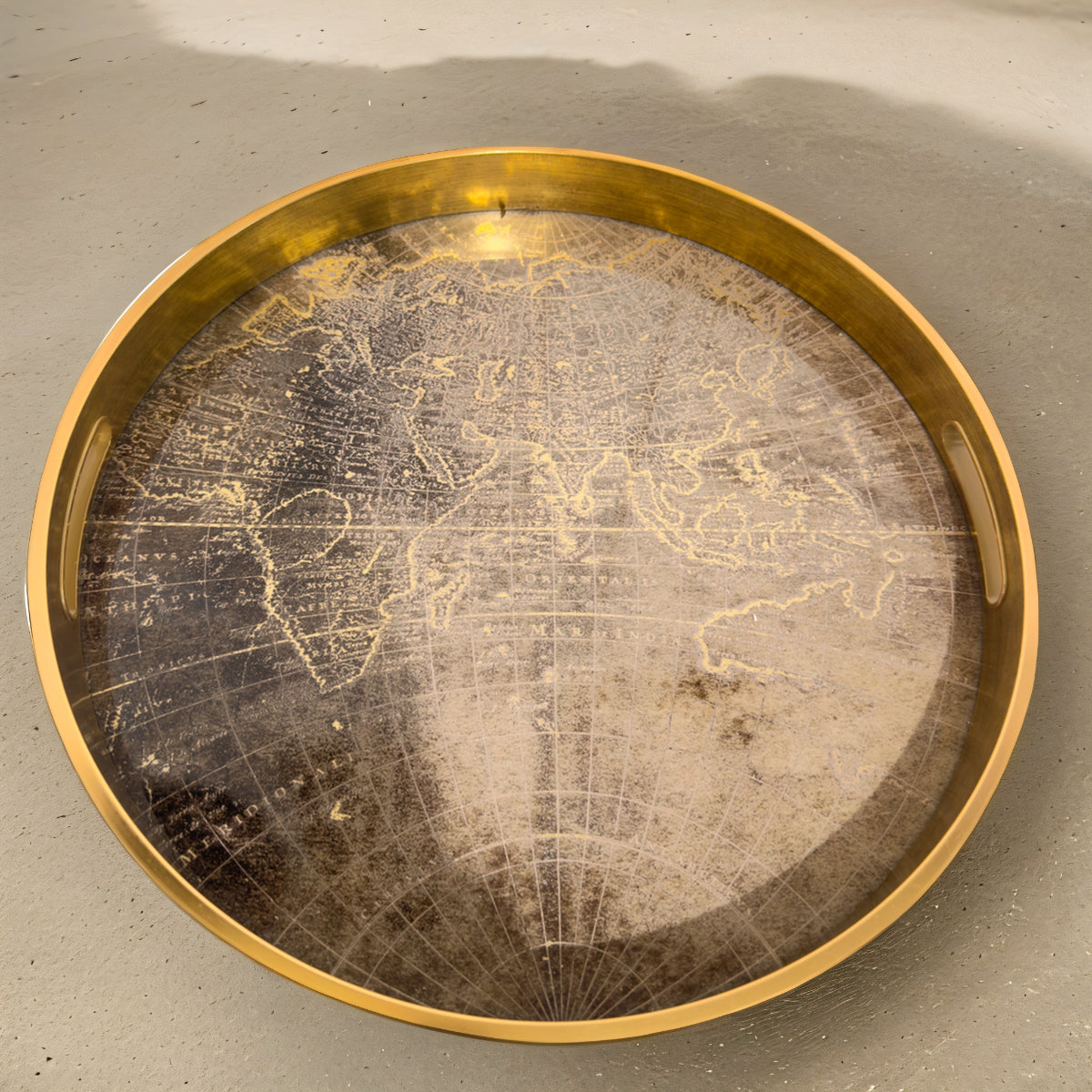 A gold tray featuring a metallic atlas map pattern on the base of the tray.