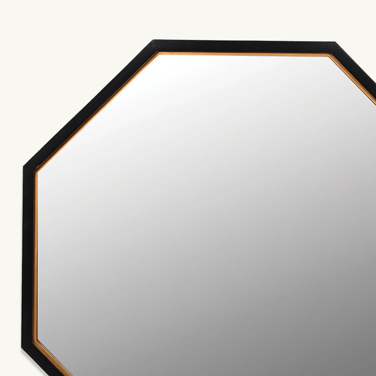 A close up of a black & gold octagonal wall mirror.