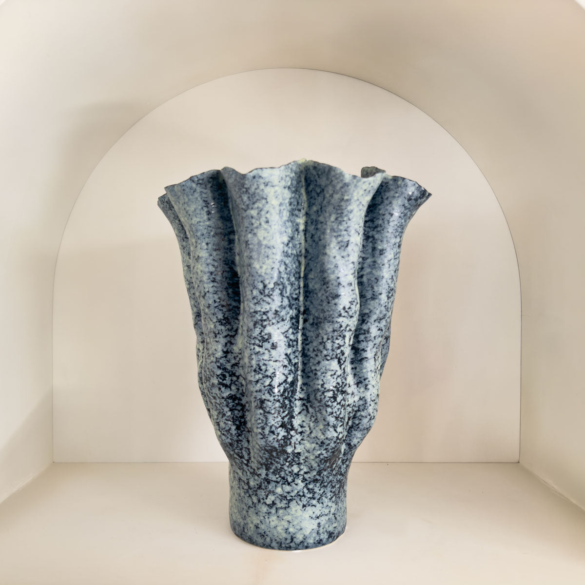 Textured blue vase on a white background