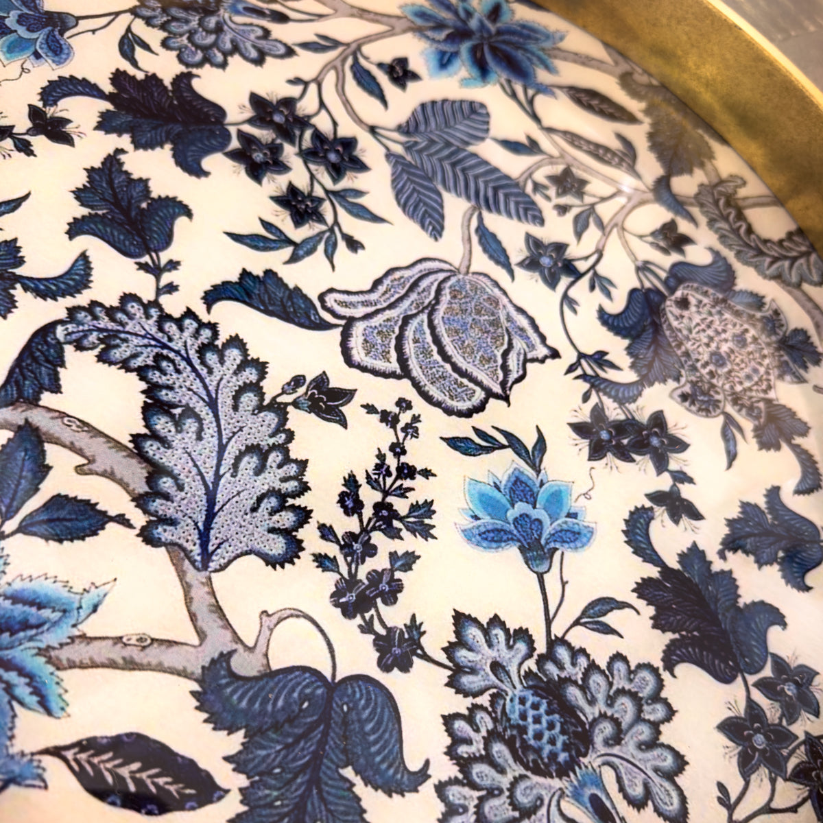 Close-up of a floral pattern tray with blue and white colors on a beige background
