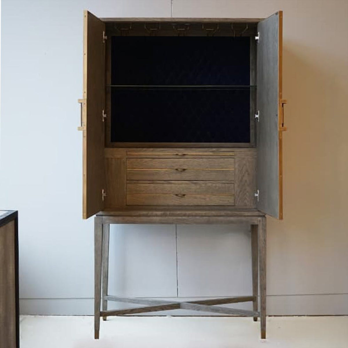 Wooden cabinet with open doors on a white background