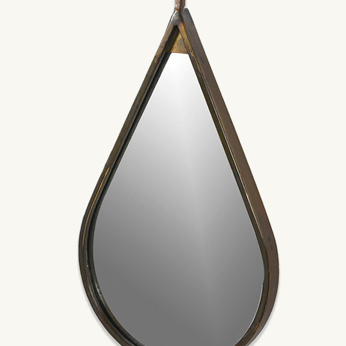 A close up of a teardrop shaped mirror with an antique gold frame.