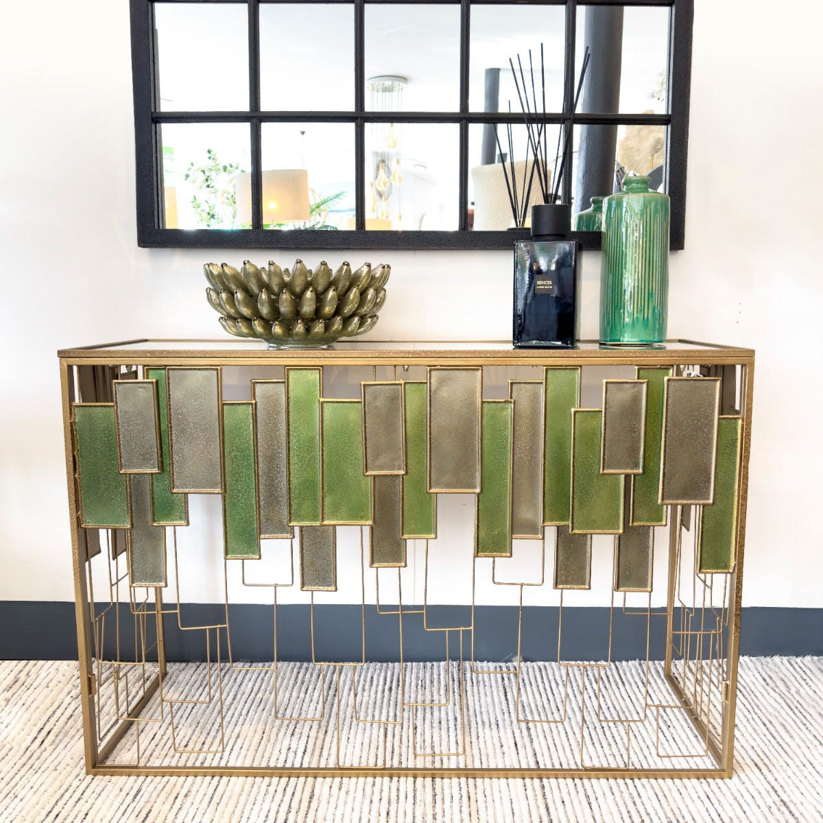 Decorative console table with geometric design and decorative items in a room.