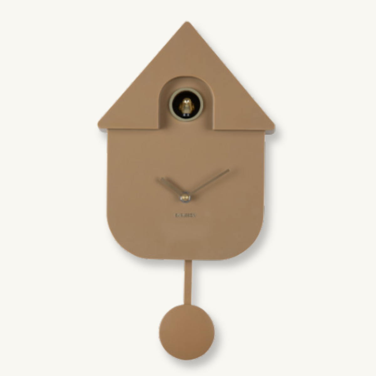 Minimalist tan cuckoo clock shaped like a house, with a small round window, simple hands, and a hanging pendulum against a cream background.