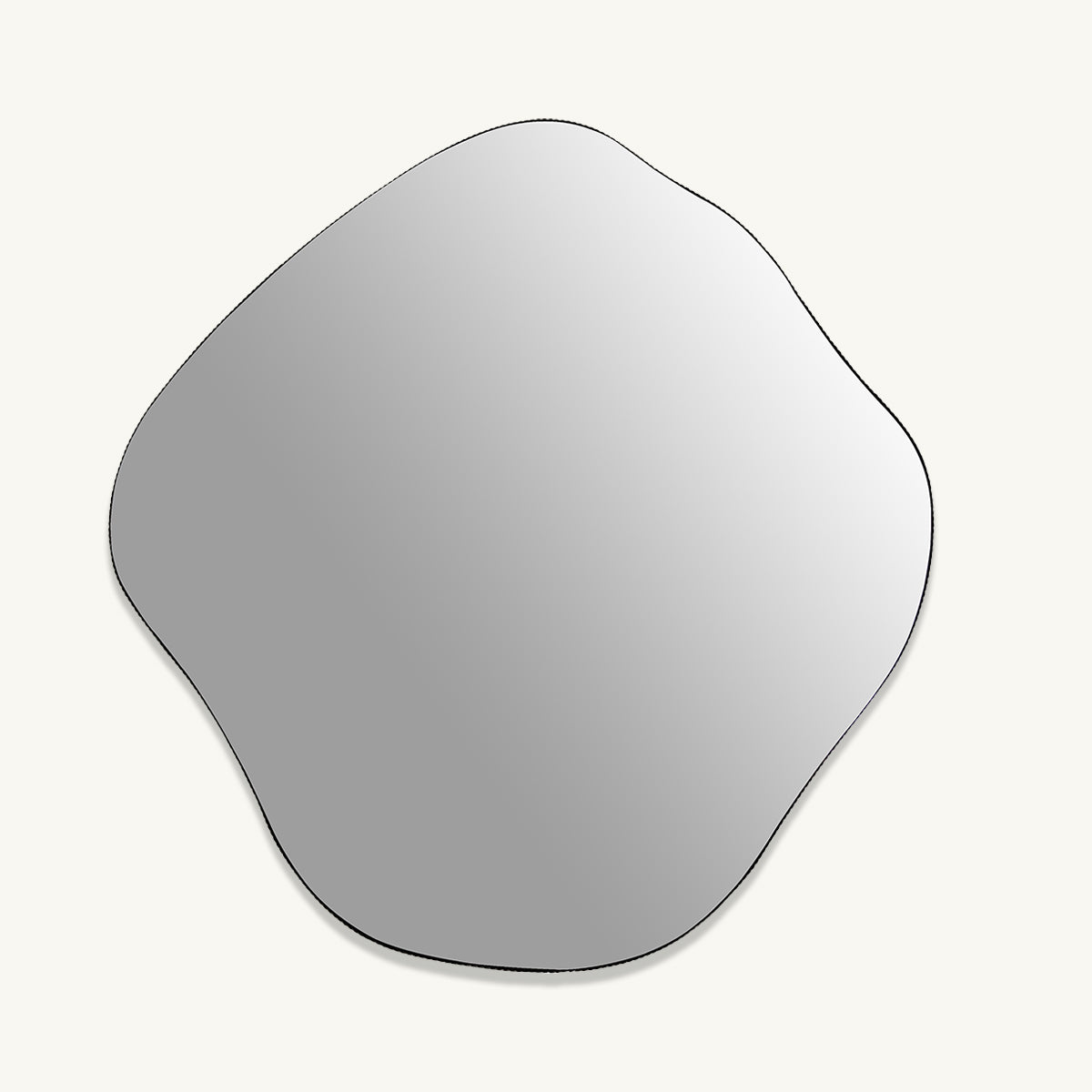An organic shaped mirror with a ridged oak frame.