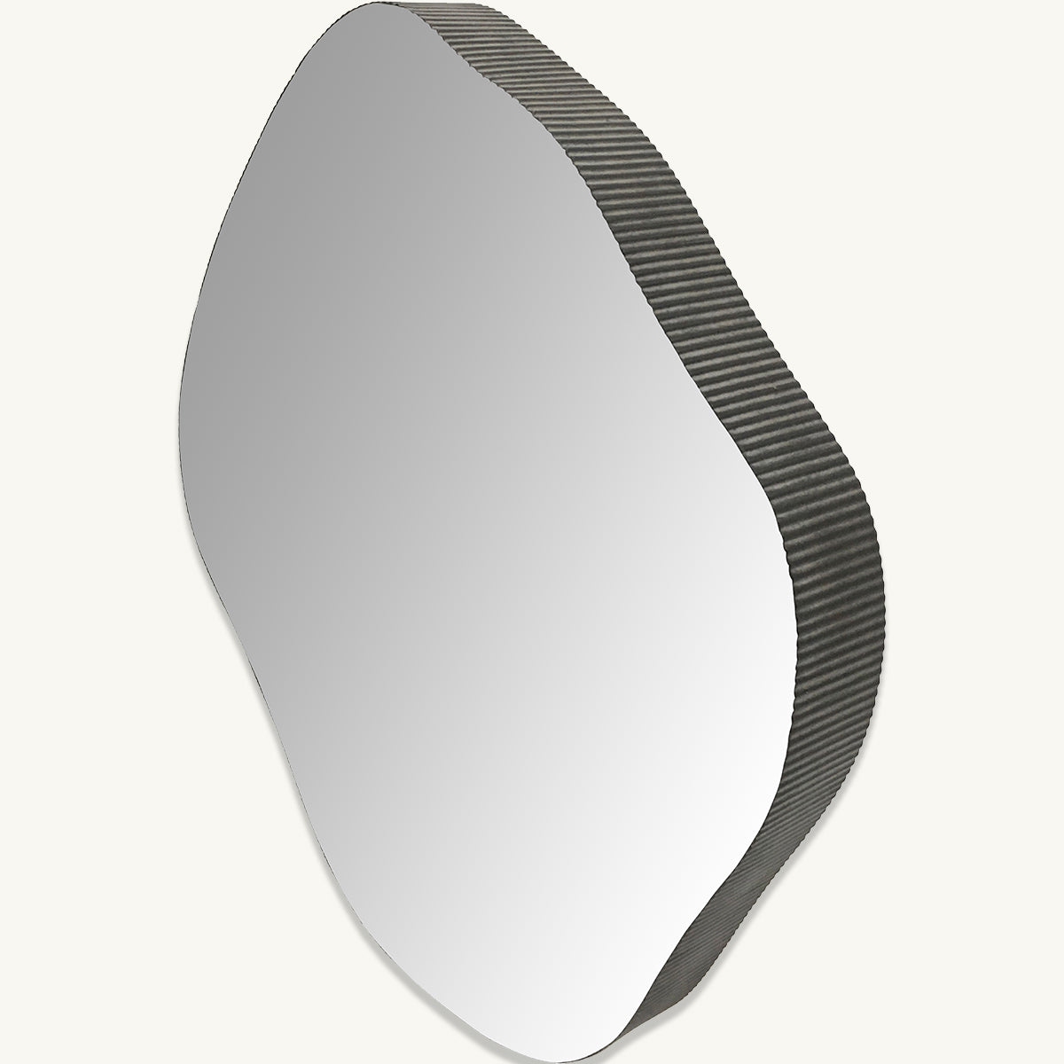An organic shaped mirror with an oak frame that has a ridged texture.