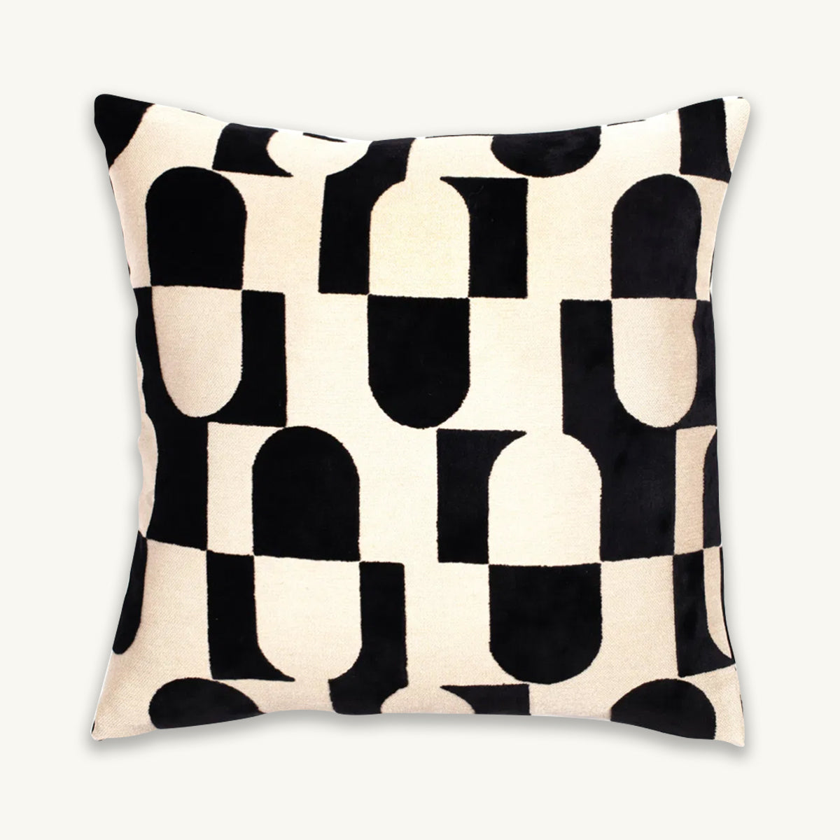 Decorative cushion with black and white abstract pattern on a beige background