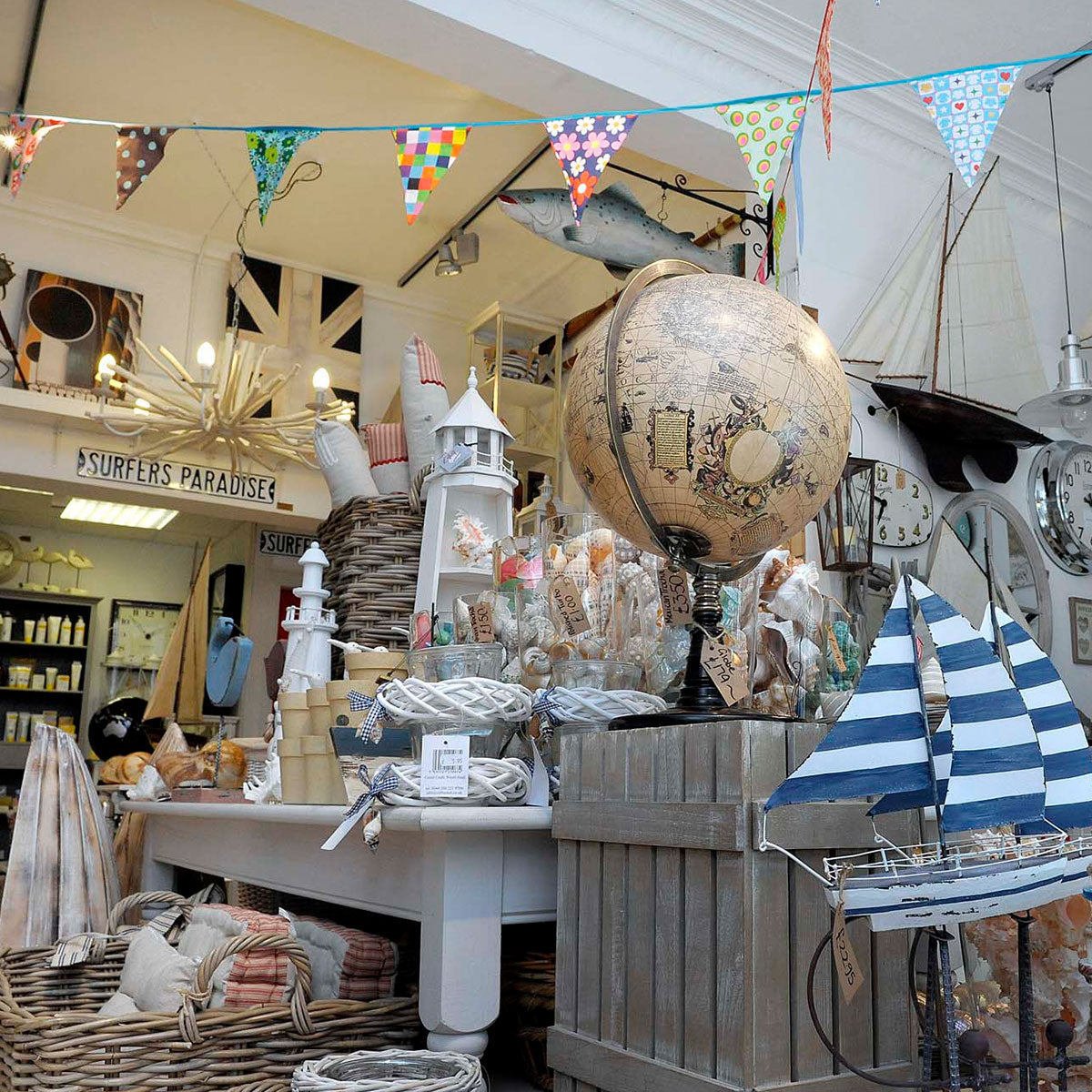 Nautical-themed store interior with a globe, model sailboat, and various decorative items.