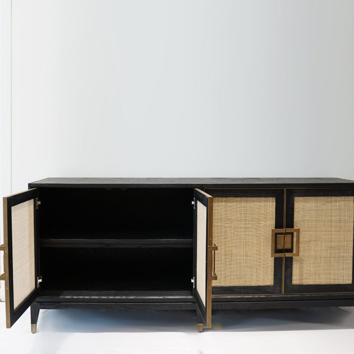 Black cabinet with wicker doors on a white background