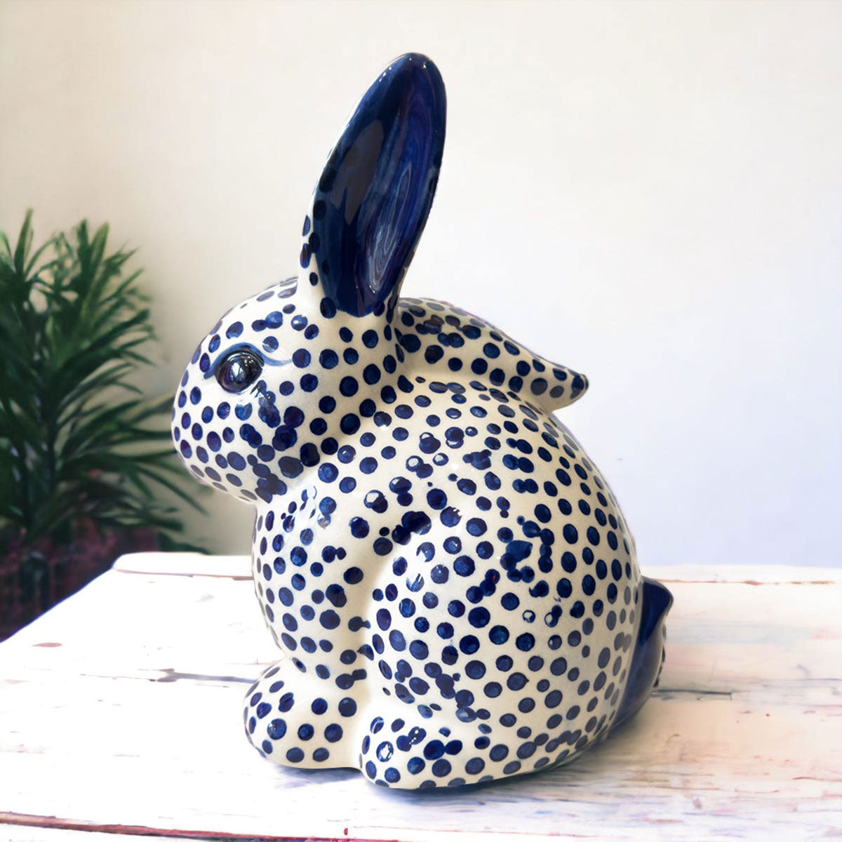 Ceramic rabbit with blue dot pattern on a white surface