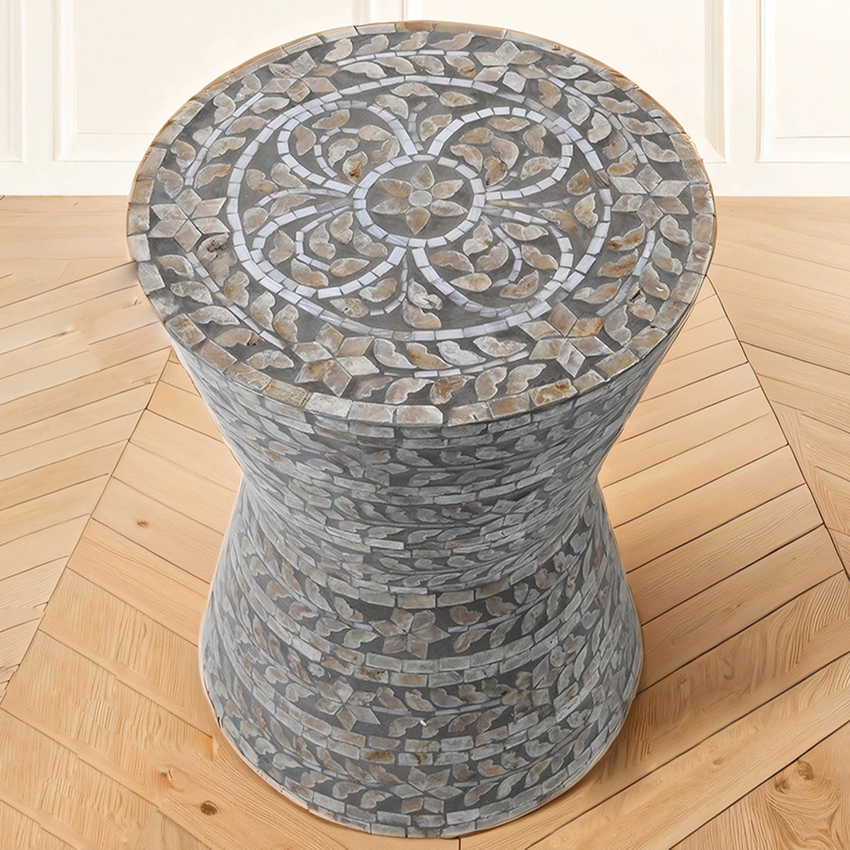 Decorative capiz table with a mosaic top on a wooden floor