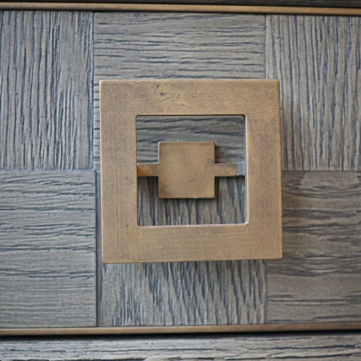 Decorative console table with geometric handle on a textured surface