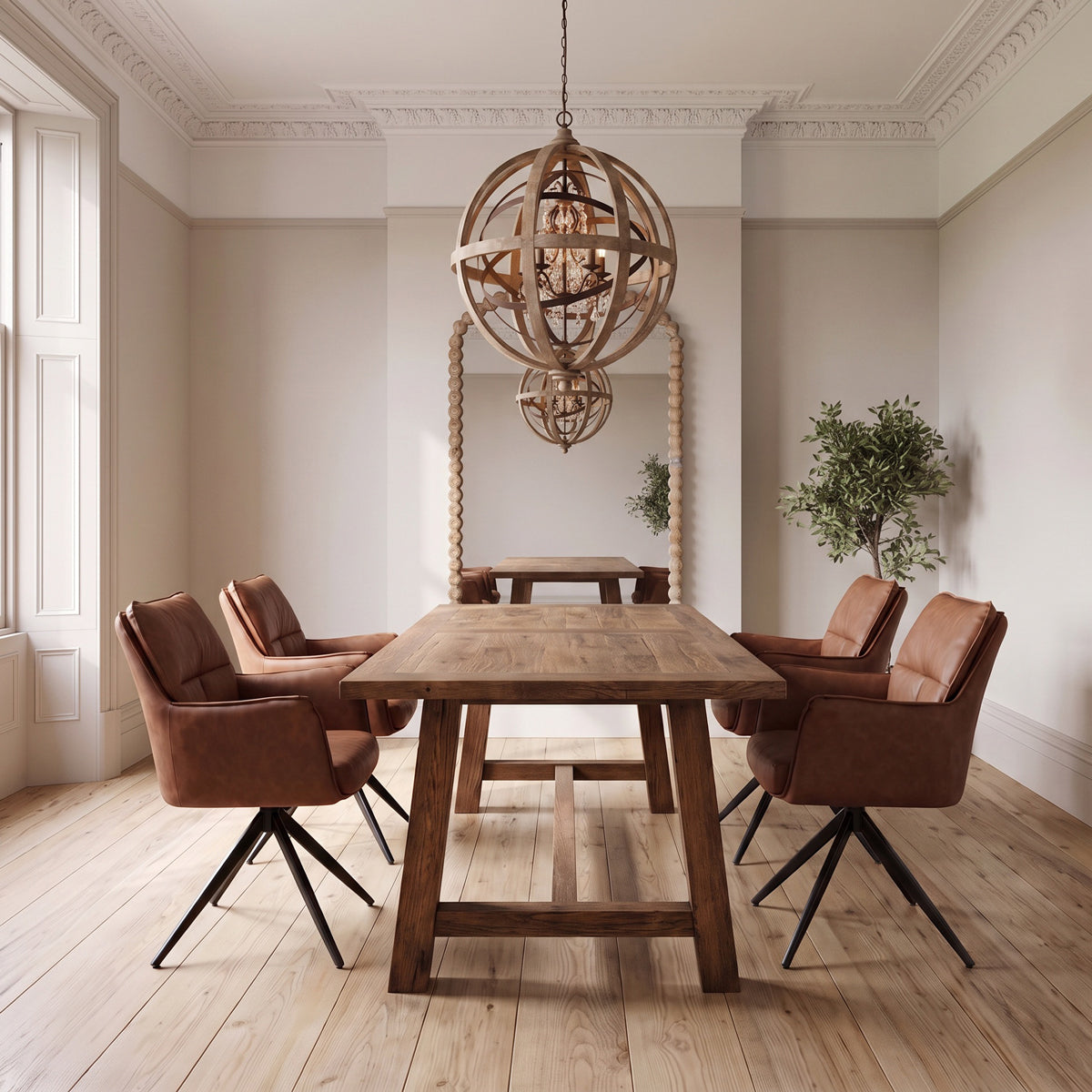 A rustic wooden dining table surrounded by four brown leather swivel chairs in a bright, elegant room with a large spherical wooden chandelier.