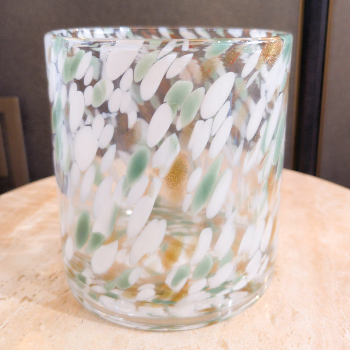 Decorative glass vase with a pattern on a wooden surface