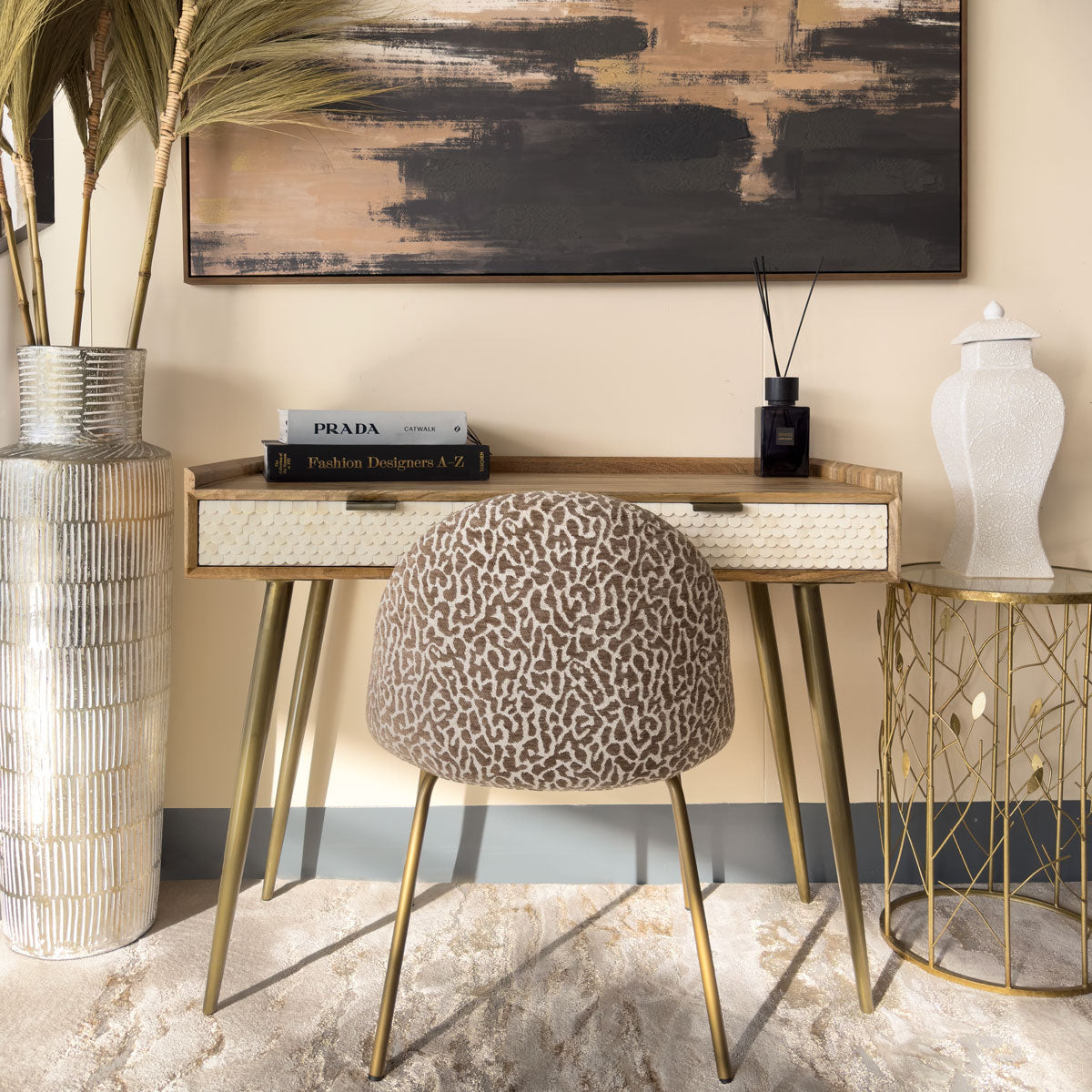 Decorative interior setting with a patterned console table and animal print dining chair
