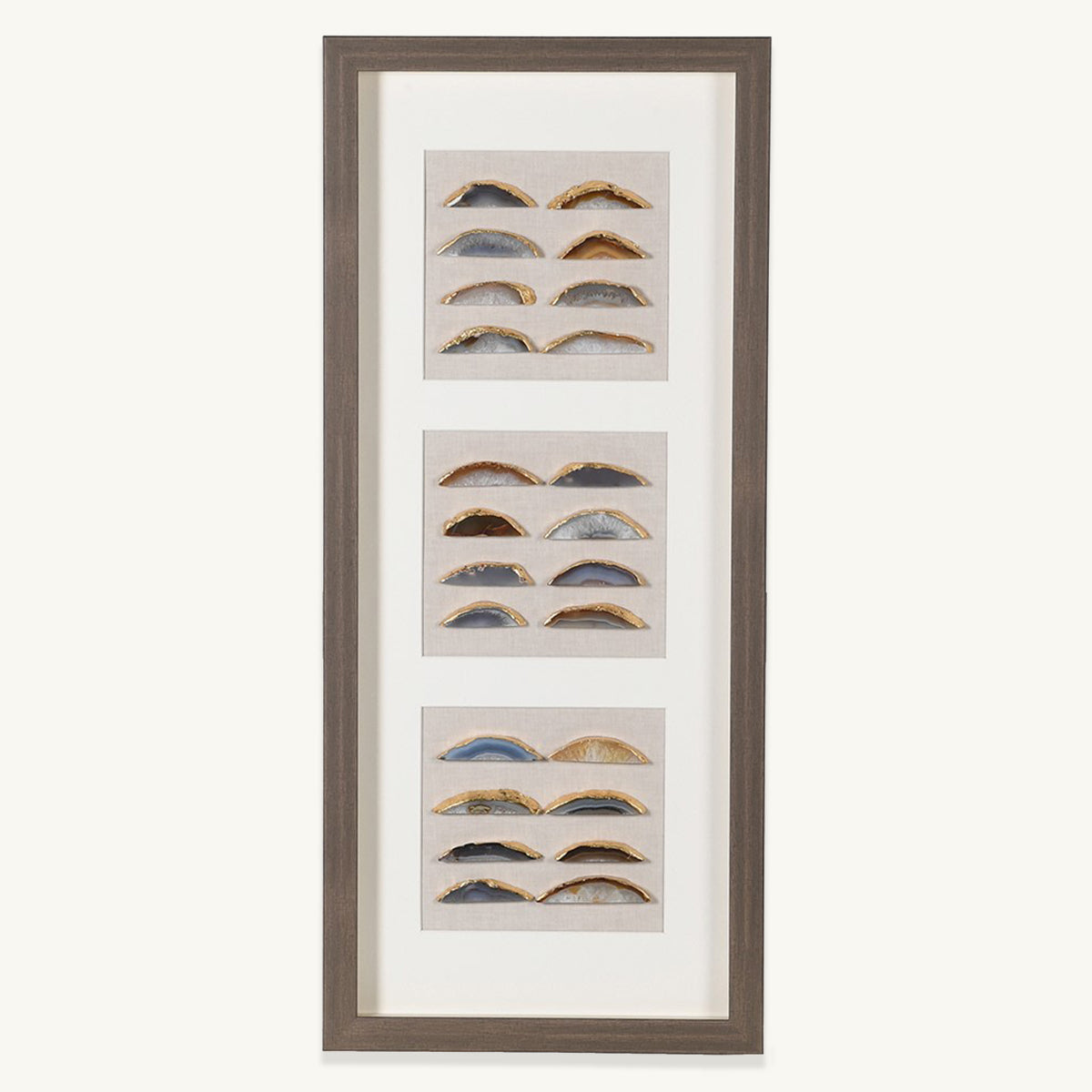 A shadow box framed wall art containing three sets of 8 agate pieces in varying colours.