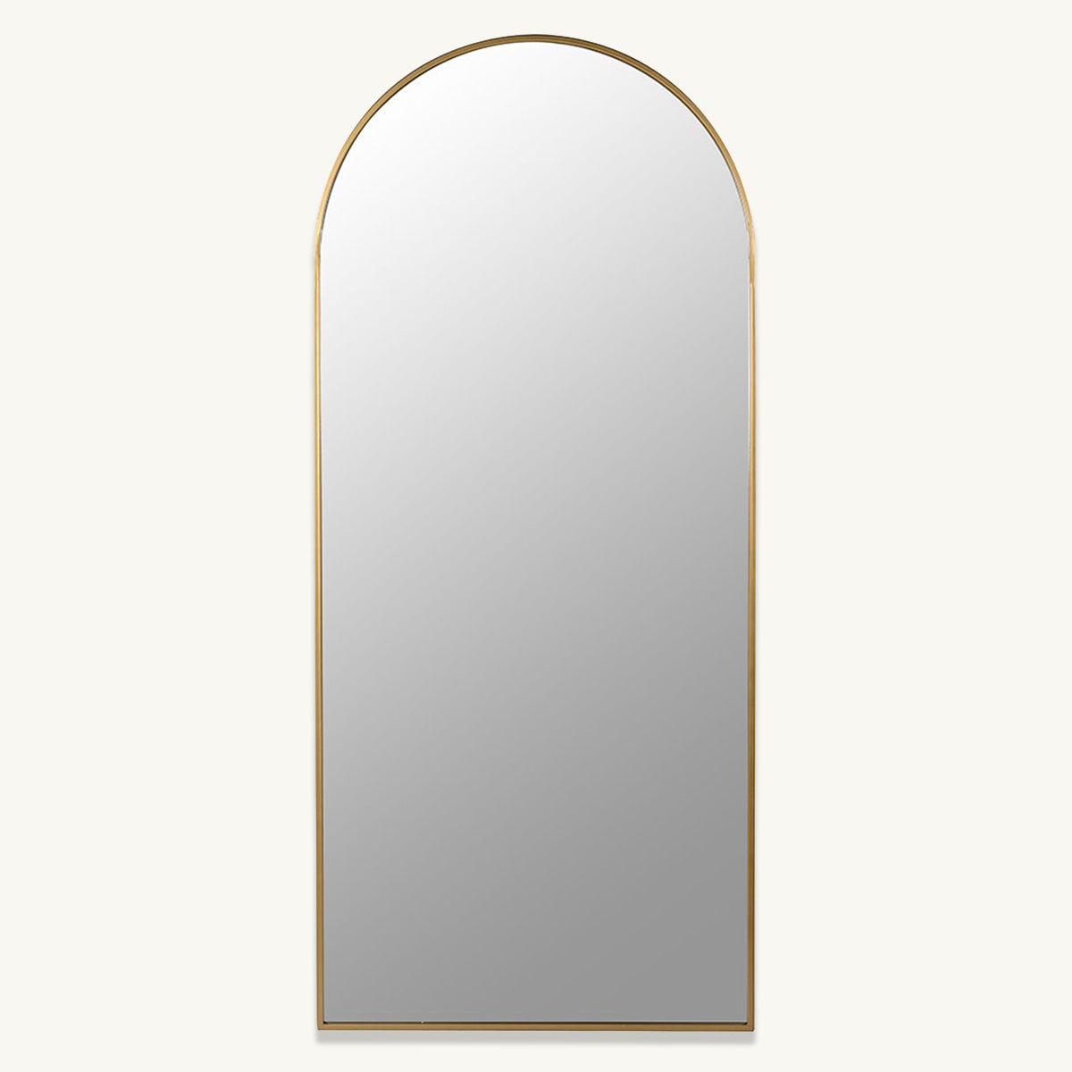A gold full length wall mirror with an arched top.