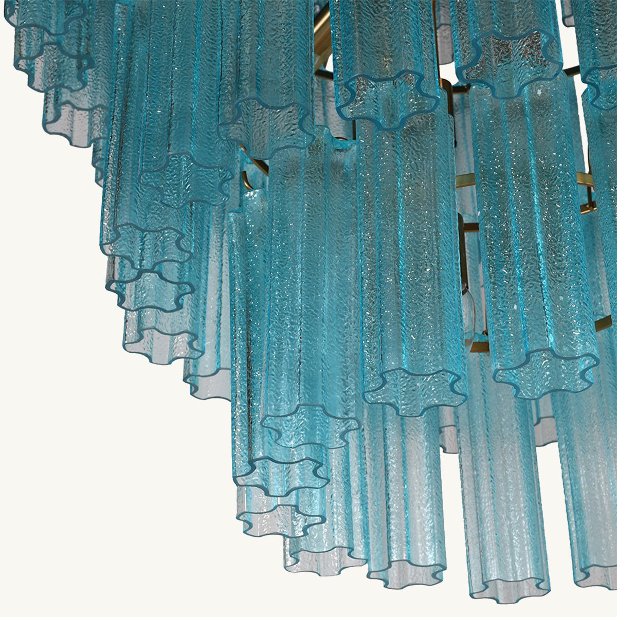 Close-up of blue textured chandelier with a white background