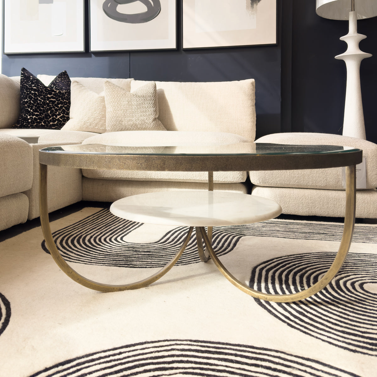 Modern living room with a coffee table, sofa, and decorative pillows.