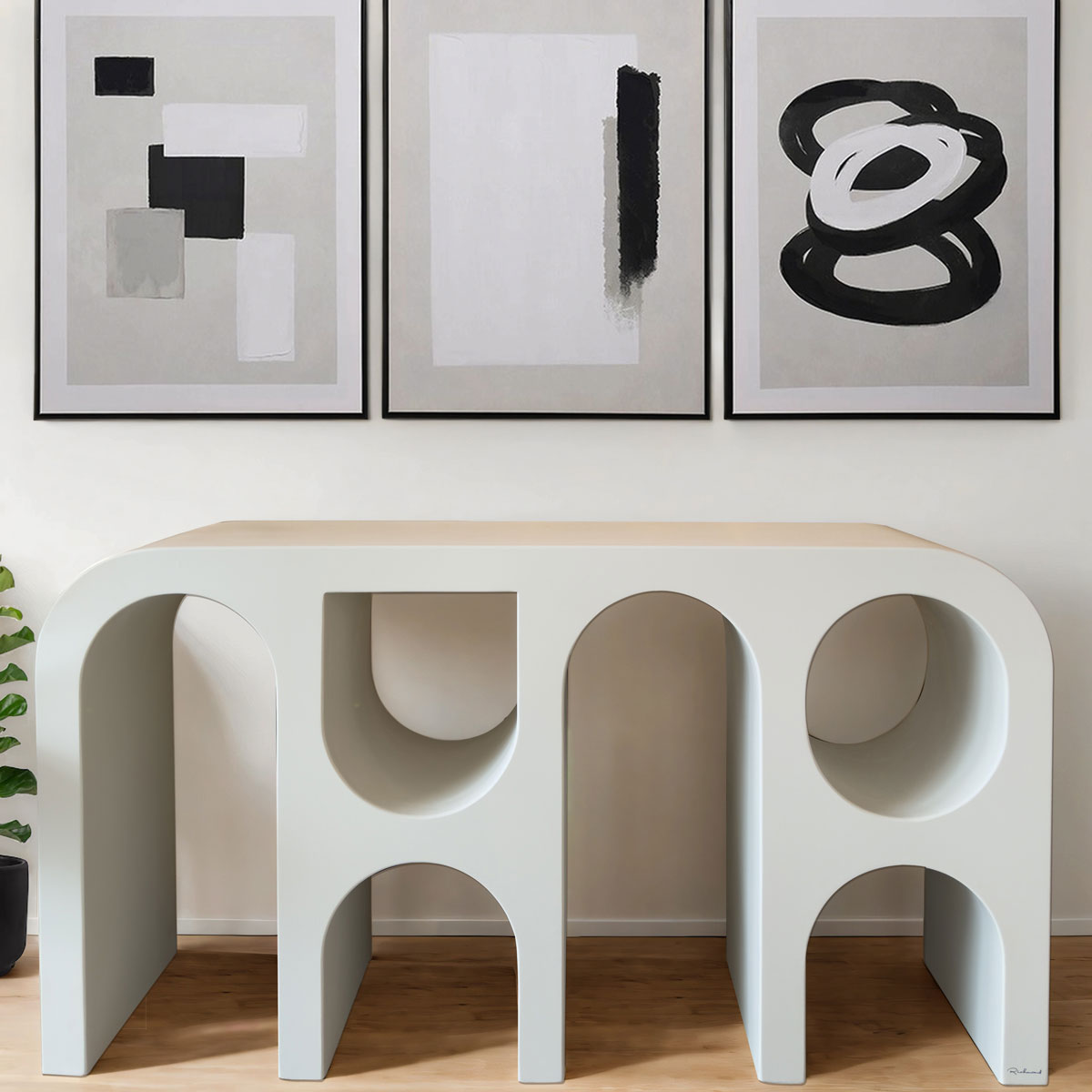 Modern white console table with abstract art on a white wall
