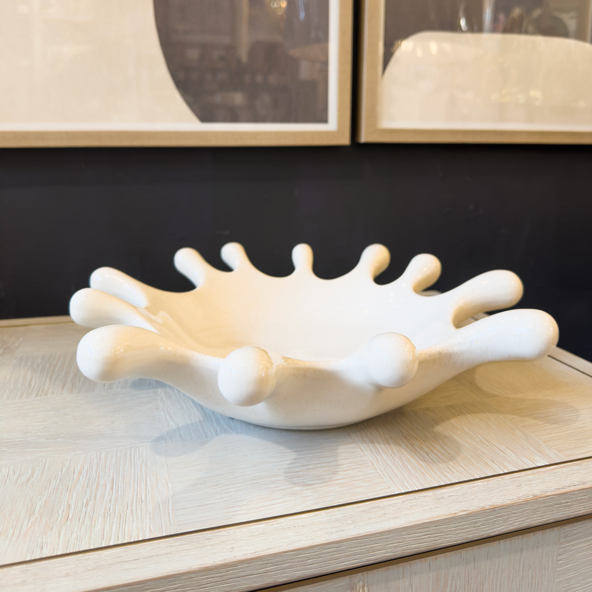 White ceramic bowl with a modern design on a wooden surface.