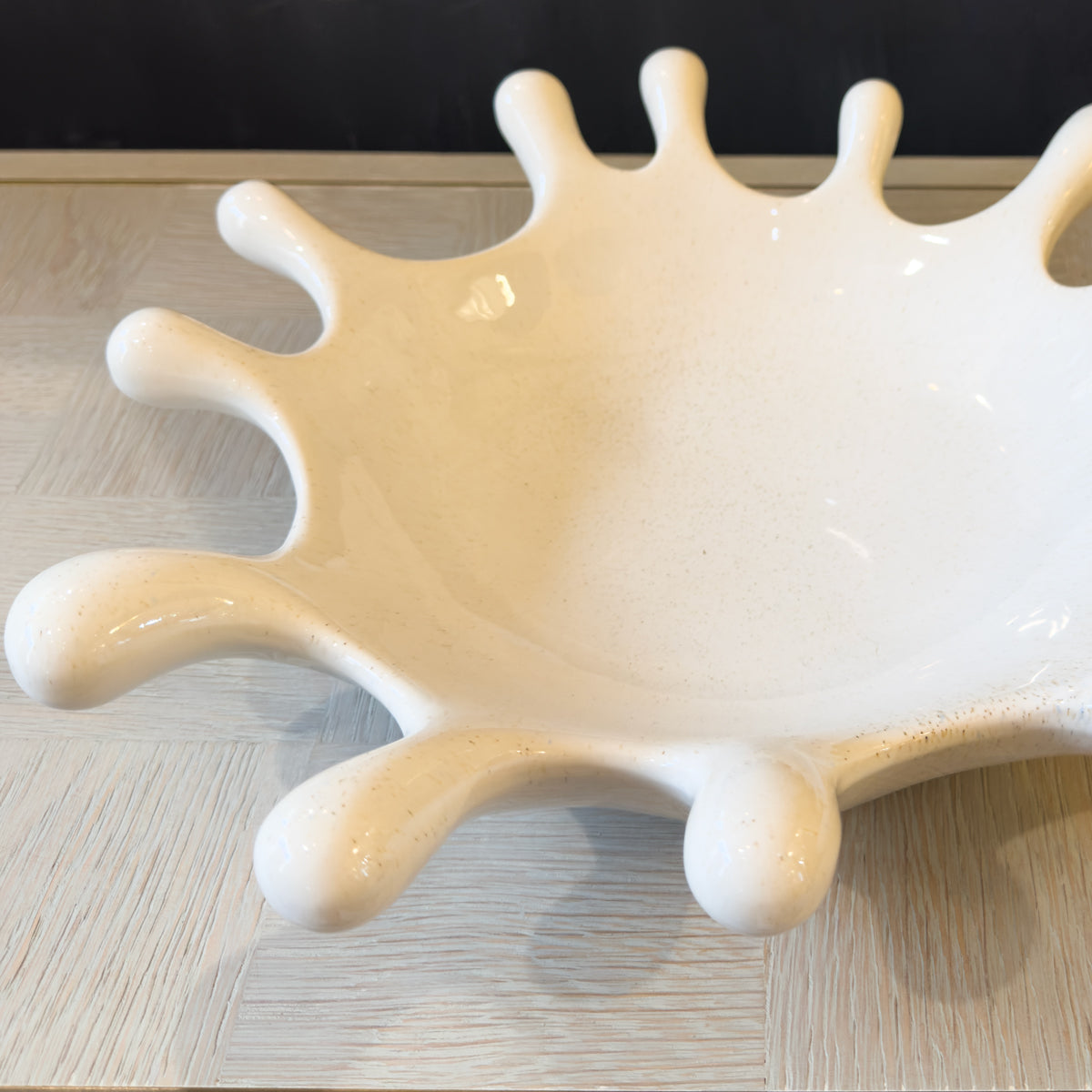 White ceramic dish with unique design on a wooden surface