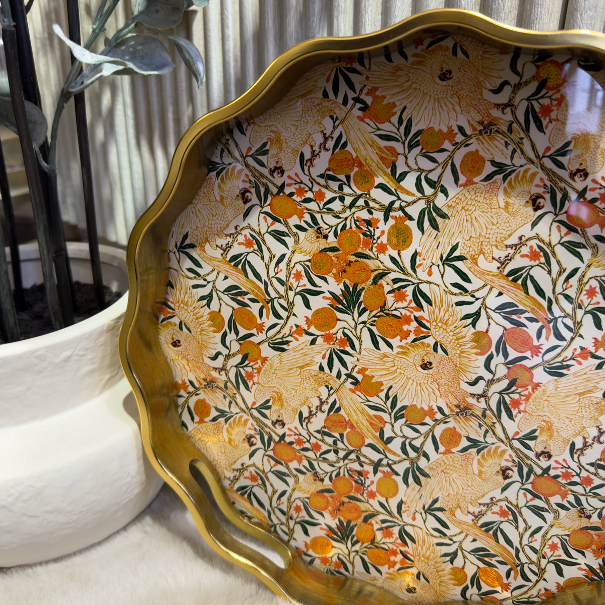 Ornate gold-rimmed decorative tray with dense floral patterns, orange fruits, birds, and butterflies.