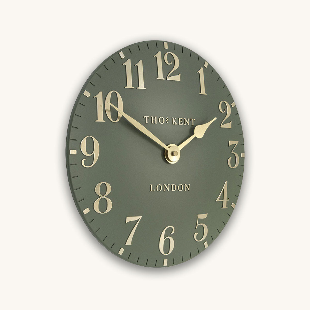 Green wall clock with gold numbers and Thomas Kent branding on a white background