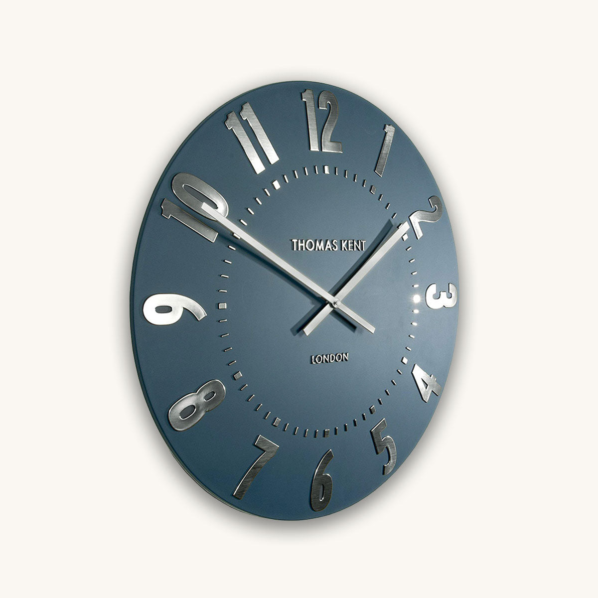 Blue wall clock with silver accents on a white background