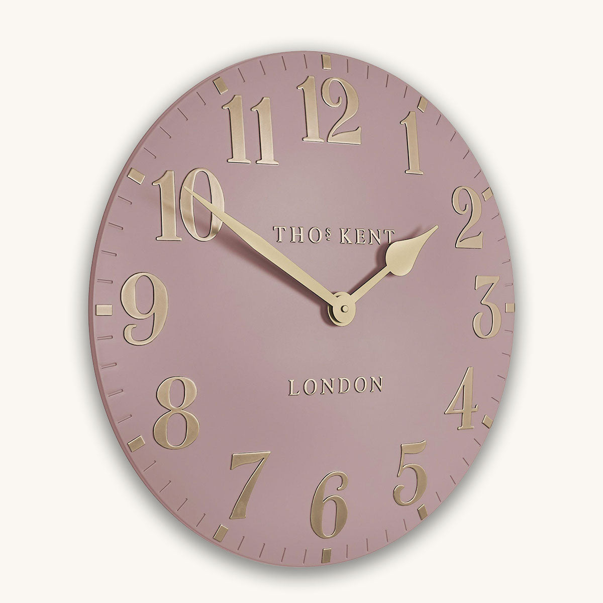 Pink wall clock with gold numbers and 'Thomas Kent London' branding