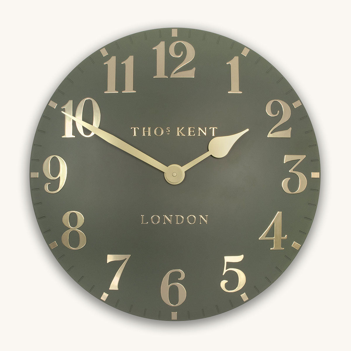 Wall clock with gold numbers and 'Thomas Kent London' branding on a dark green background