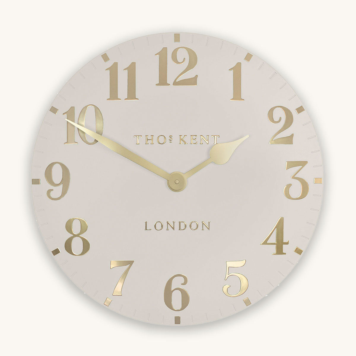 Wall clock with gold numbers and 'Thomas Kent London' branding on a light background