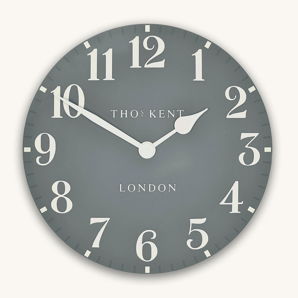 Round wall clock with white numbers and 'Thomas Kent London' branding on a gray background