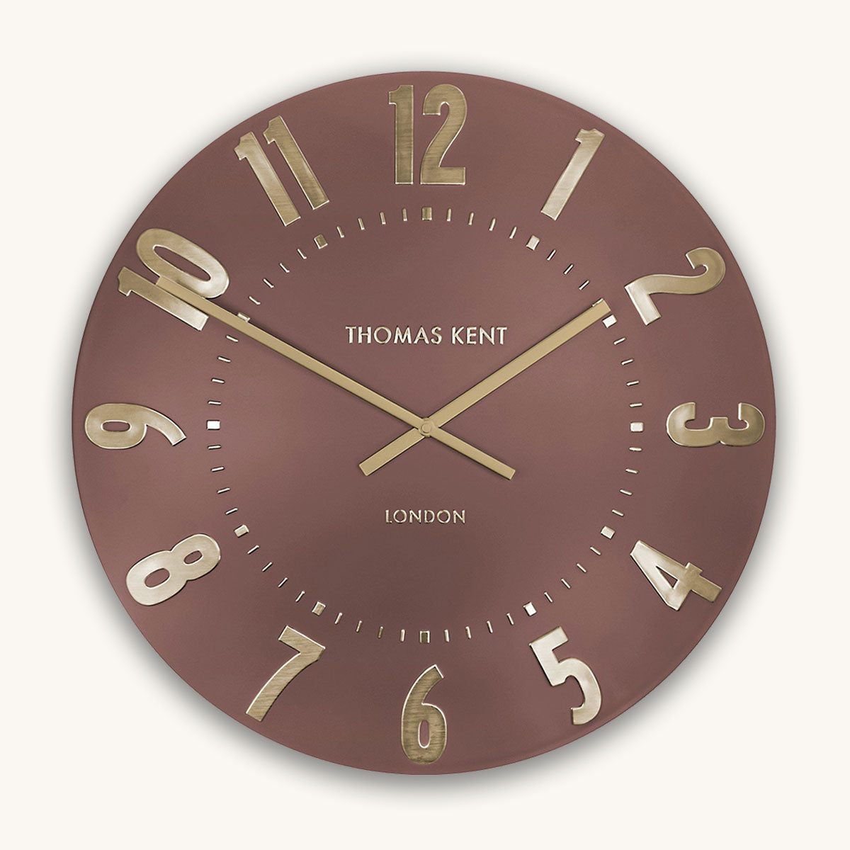 Wall clock with gold numbers and hands on a red background, branded 'Thomas Kent'.