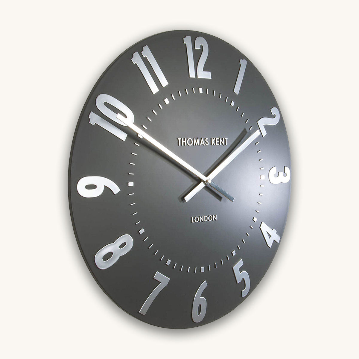 Black wall clock with white numbers and 'Thomas Kent London' branding on a white background