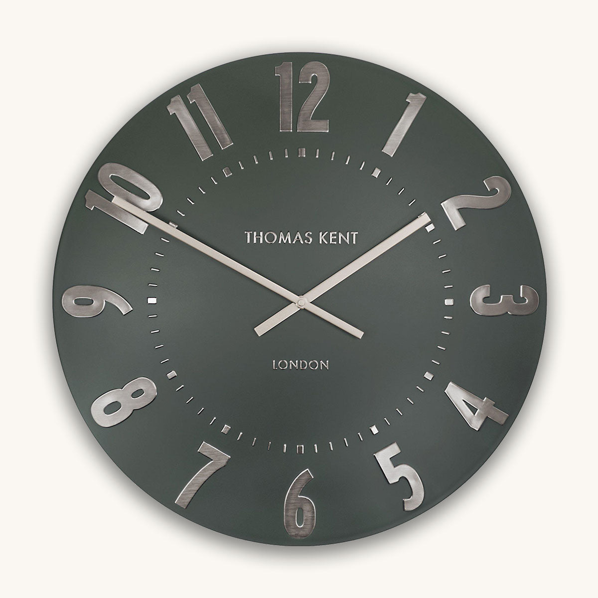 Wall clock with silver numbers and 'Thomas Kent London' branding on a dark green background