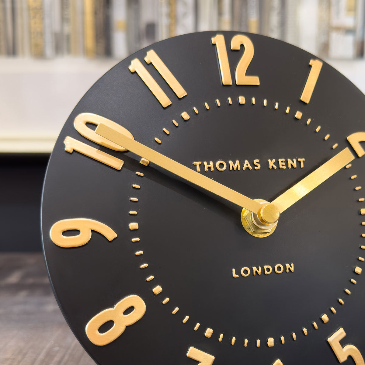 Black clock with gold numbers and 'Thomas Kent London' branding.