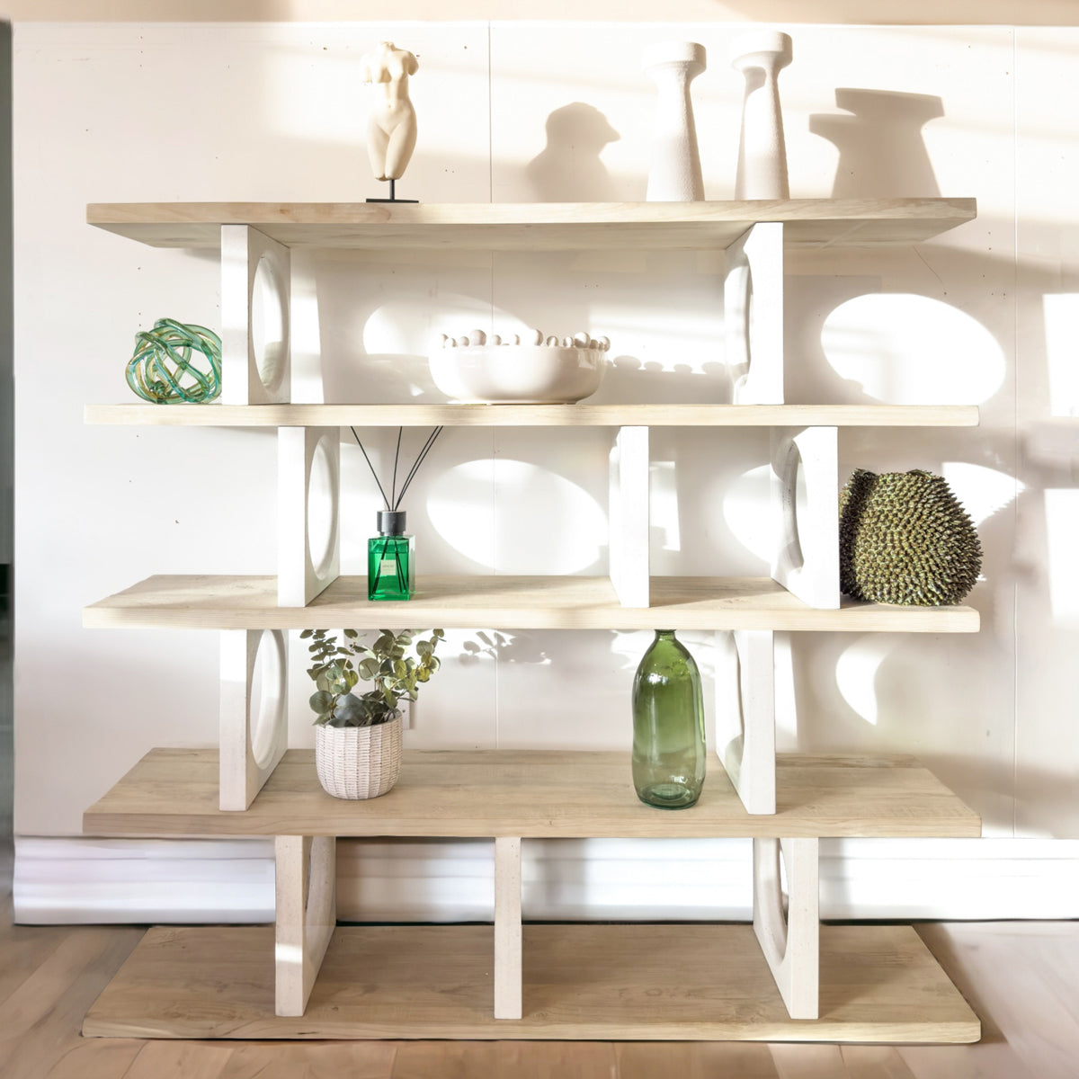 Wooden shelf with decorative items against a white wall