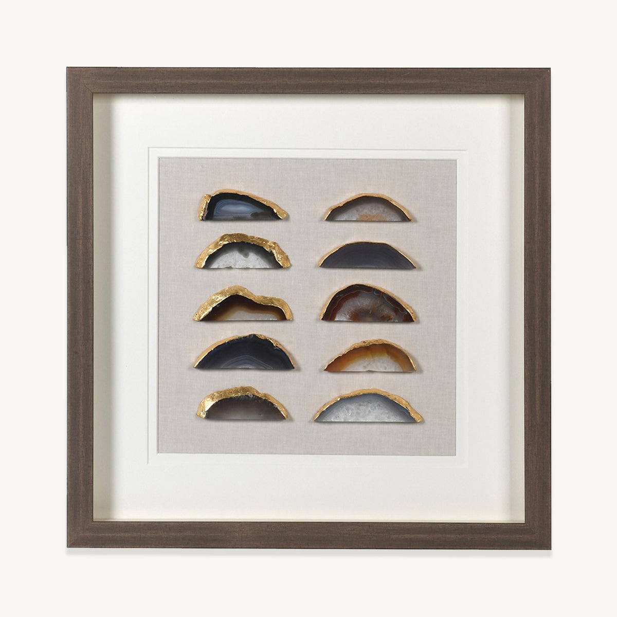A wooden framed picture containing pieces of agate crystal with gold foil detailling.