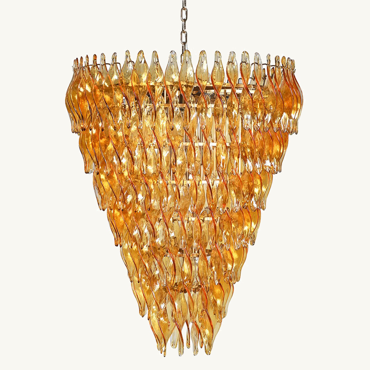 An amber tiered glass chandelier with a triangular shape and twisted glass pieces.